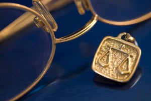 image of reading glasses and a medallion of the scales of justice
